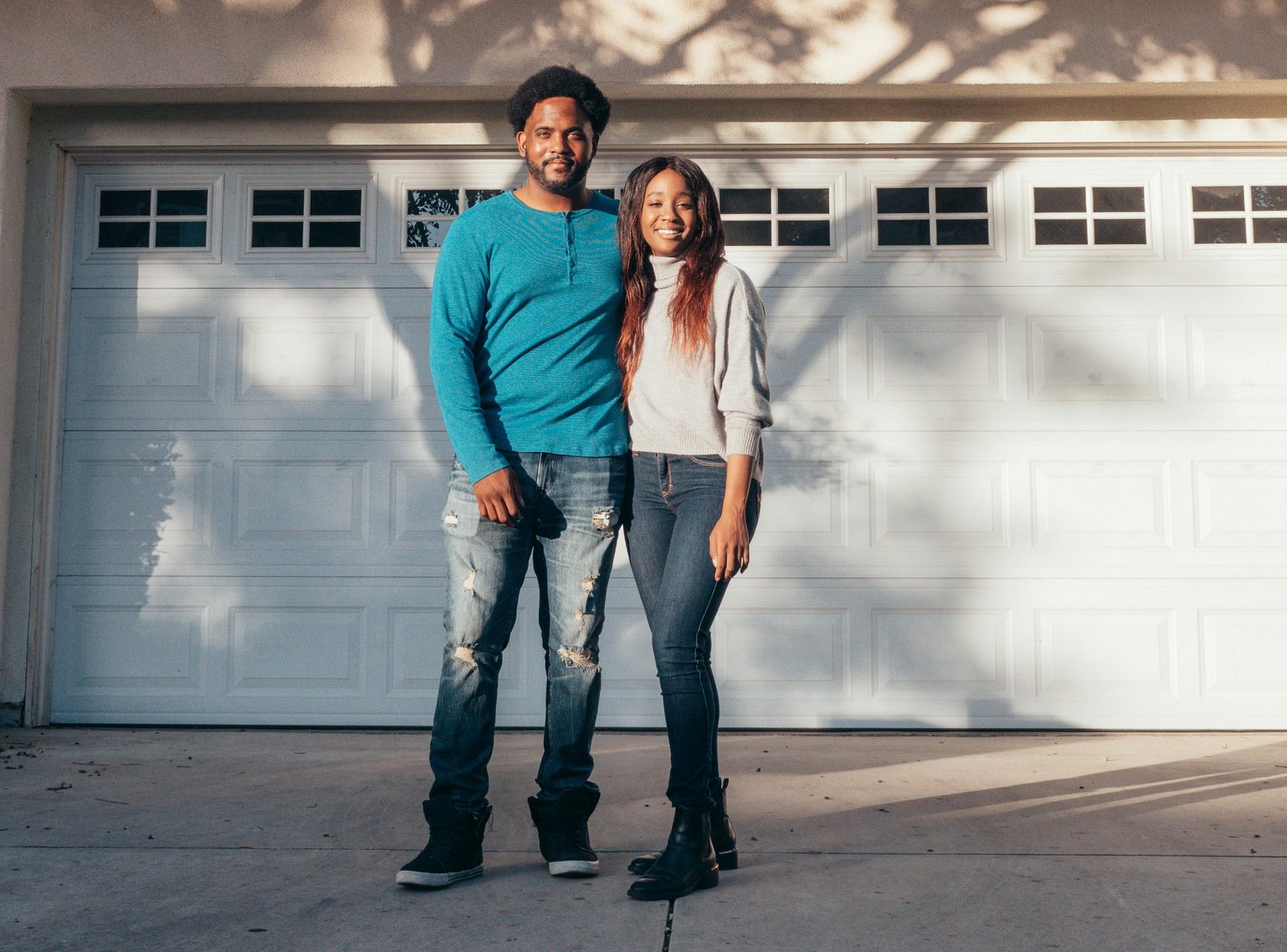 A happy couple in front of their new home